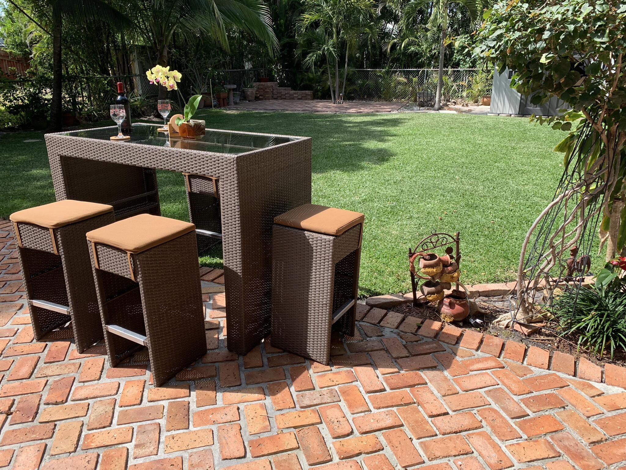 255 Cortez Road West Palm Beach, FL 33405 - Photo 6 of 26 a view of a patio with table and chairs potted plants and palm trees