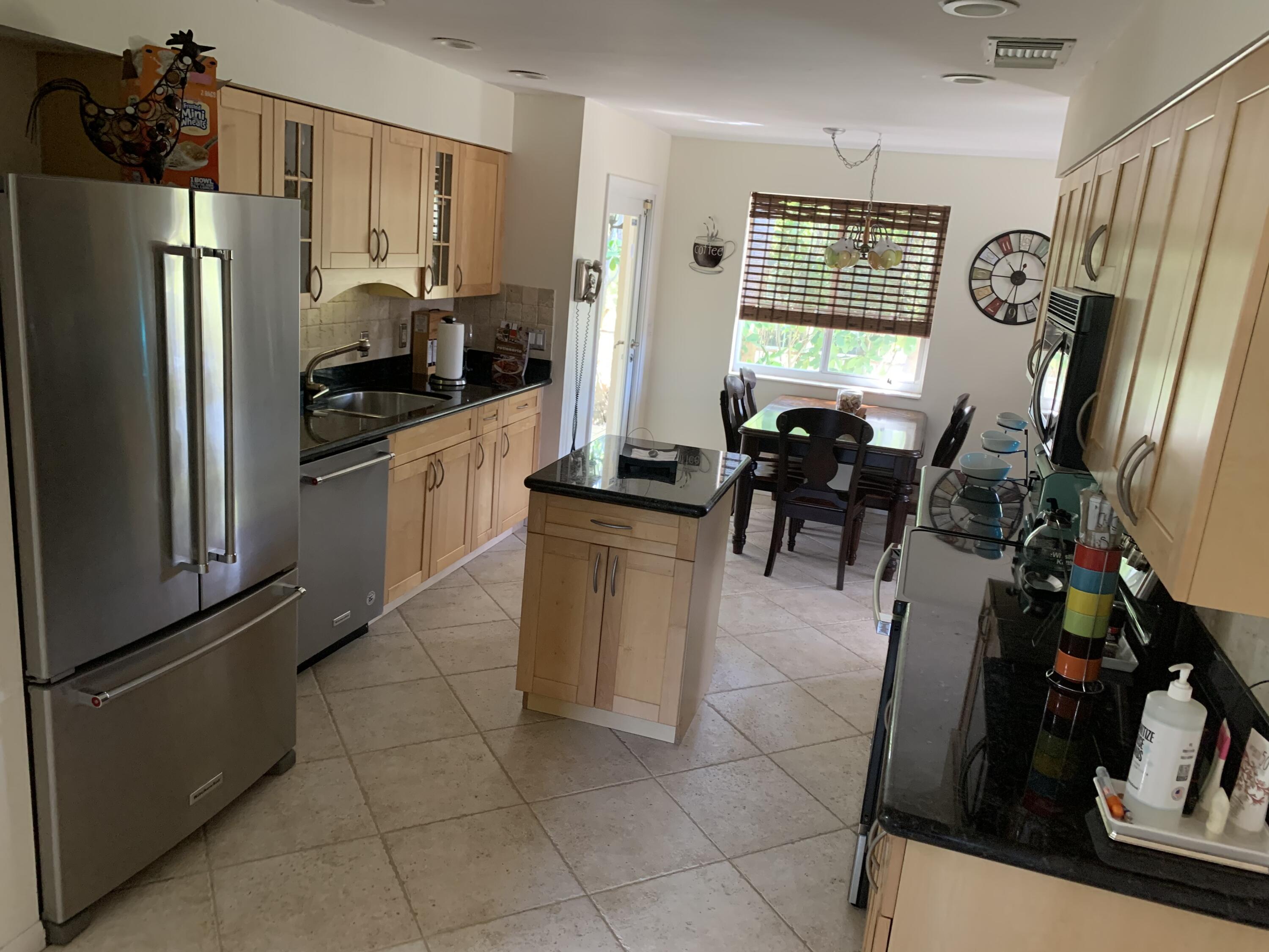 255 Cortez Road West Palm Beach, FL 33405 - Photo 8 of 26 a kitchen with stainless steel appliances granite countertop a refrigerator and a stove