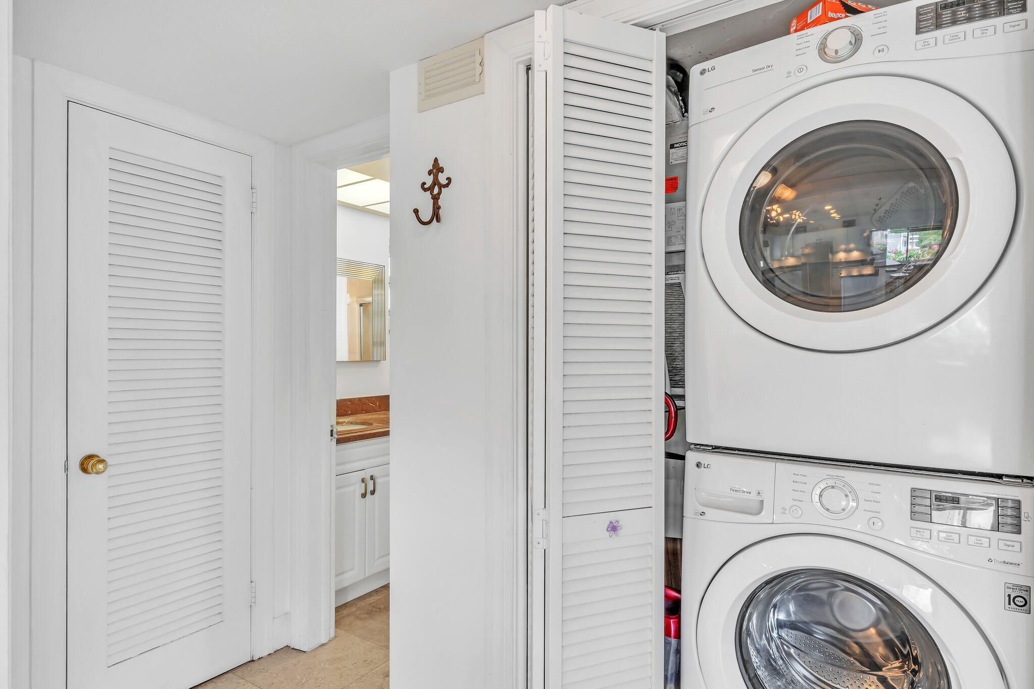 711 Northeast Harbour Terrace, Unit 4120 Boca Raton, FL 33431 - Photo 13 of 37 a view of a hallway with washer and dryer