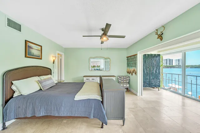 a bedroom with a large bed and a chandelier