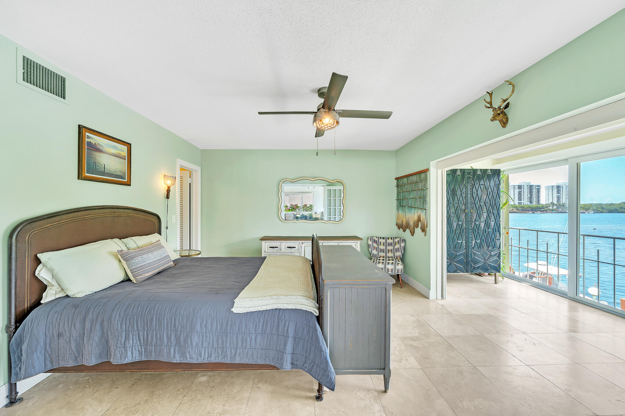 711 Northeast Harbour Terrace, Unit 4120 Boca Raton, FL 33431 - Photo 14 of 37 a bedroom with a large bed and a chandelier