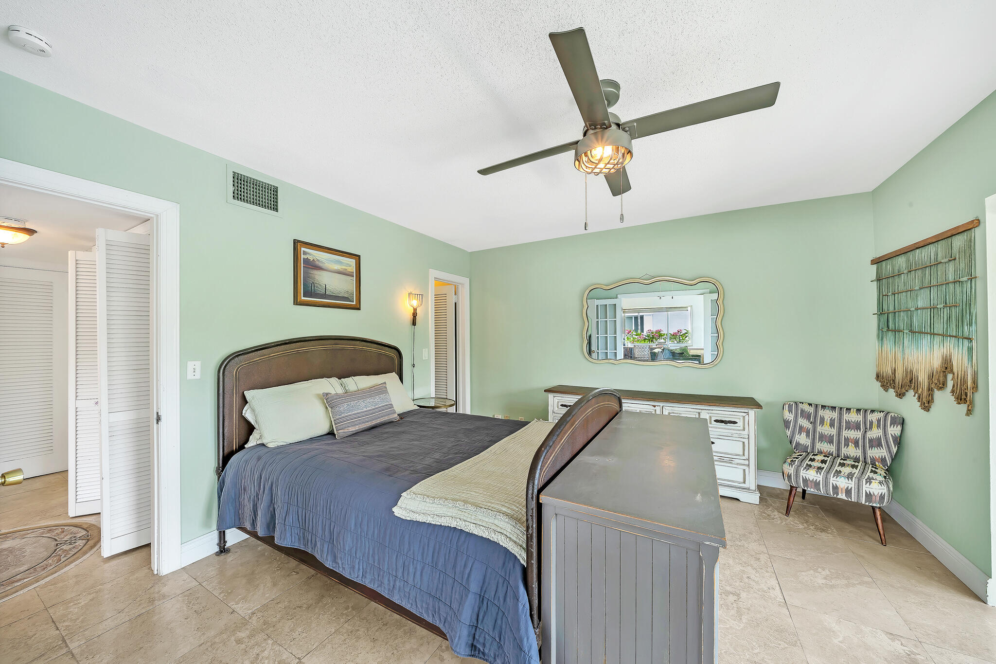 711 Northeast Harbour Terrace, Unit 4120 Boca Raton, FL 33431 - Photo 15 of 37 a bedroom with a bed and a chandelier