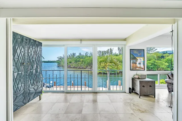 a view of a room with furniture and a large window