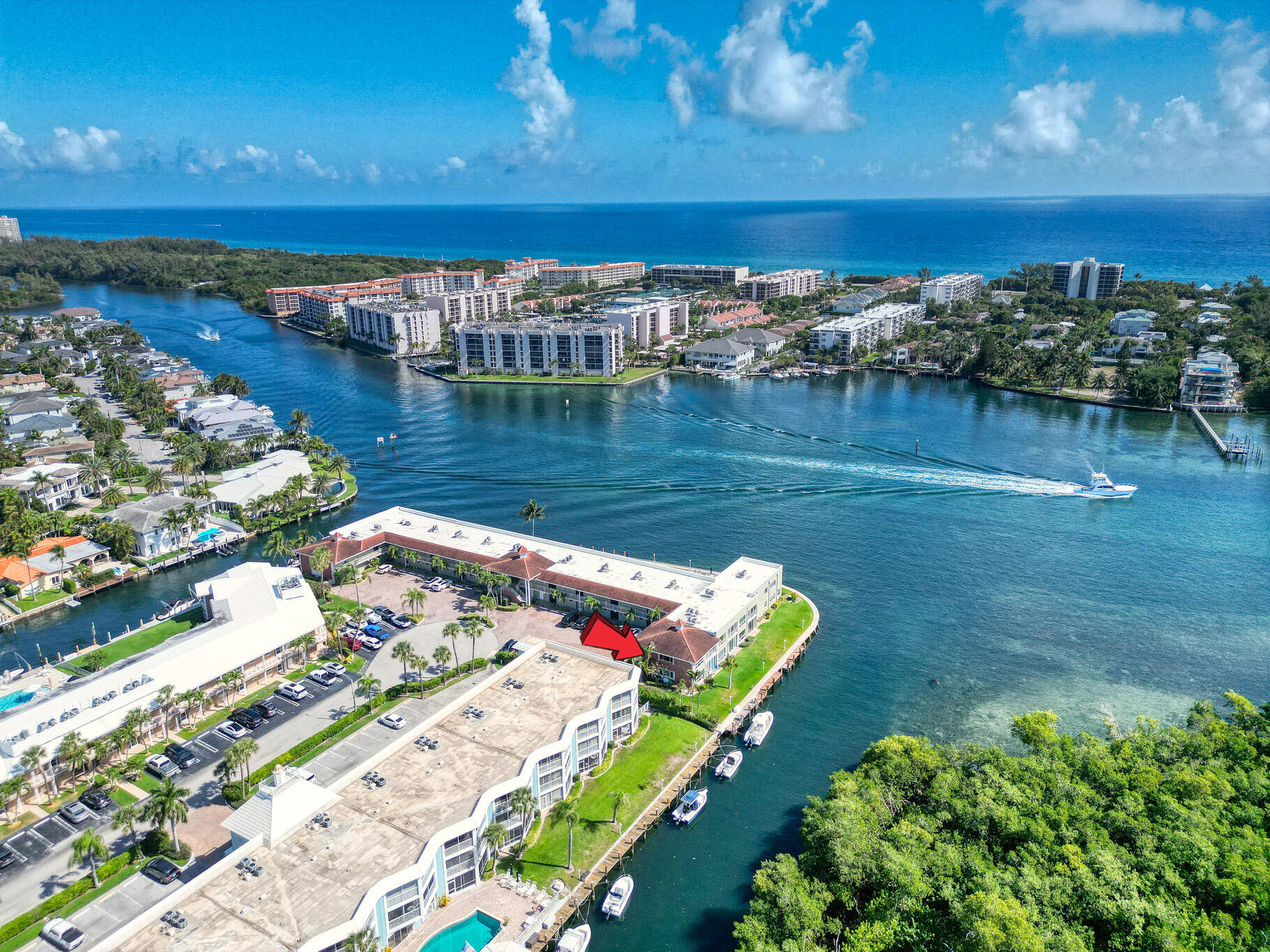 711 Northeast Harbour Terrace, Unit 4120 Boca Raton, FL 33431 - Photo 2 of 37 a view of a lake with a building in the background