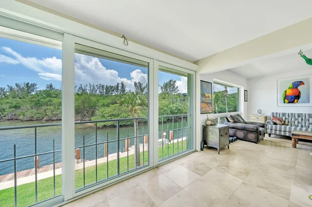 a living room filled with furniture and a large window