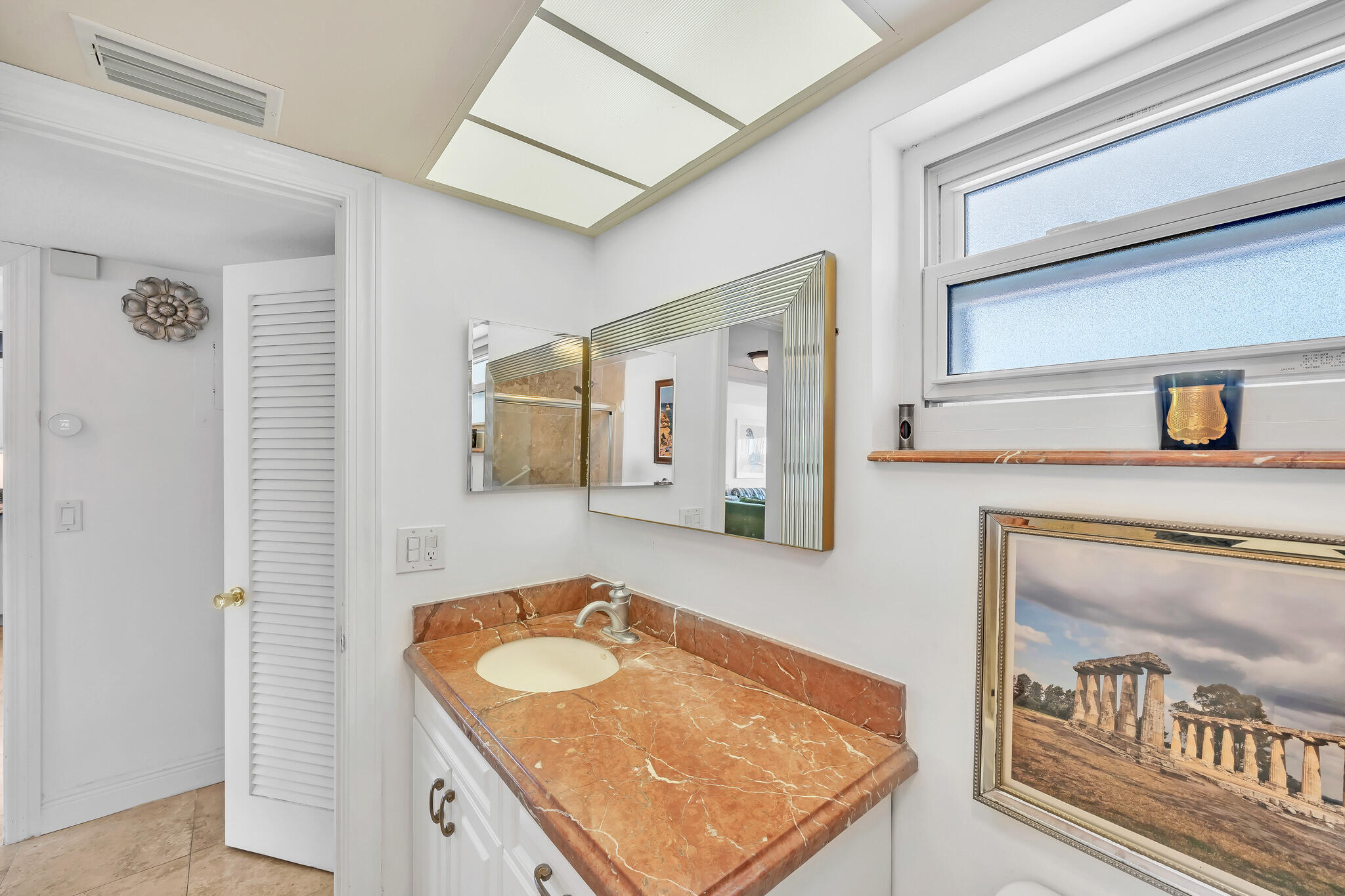 711 Northeast Harbour Terrace, Unit 4120 Boca Raton, FL 33431 - Photo 31 of 37 a bathroom with a granite countertop sink and a mirror