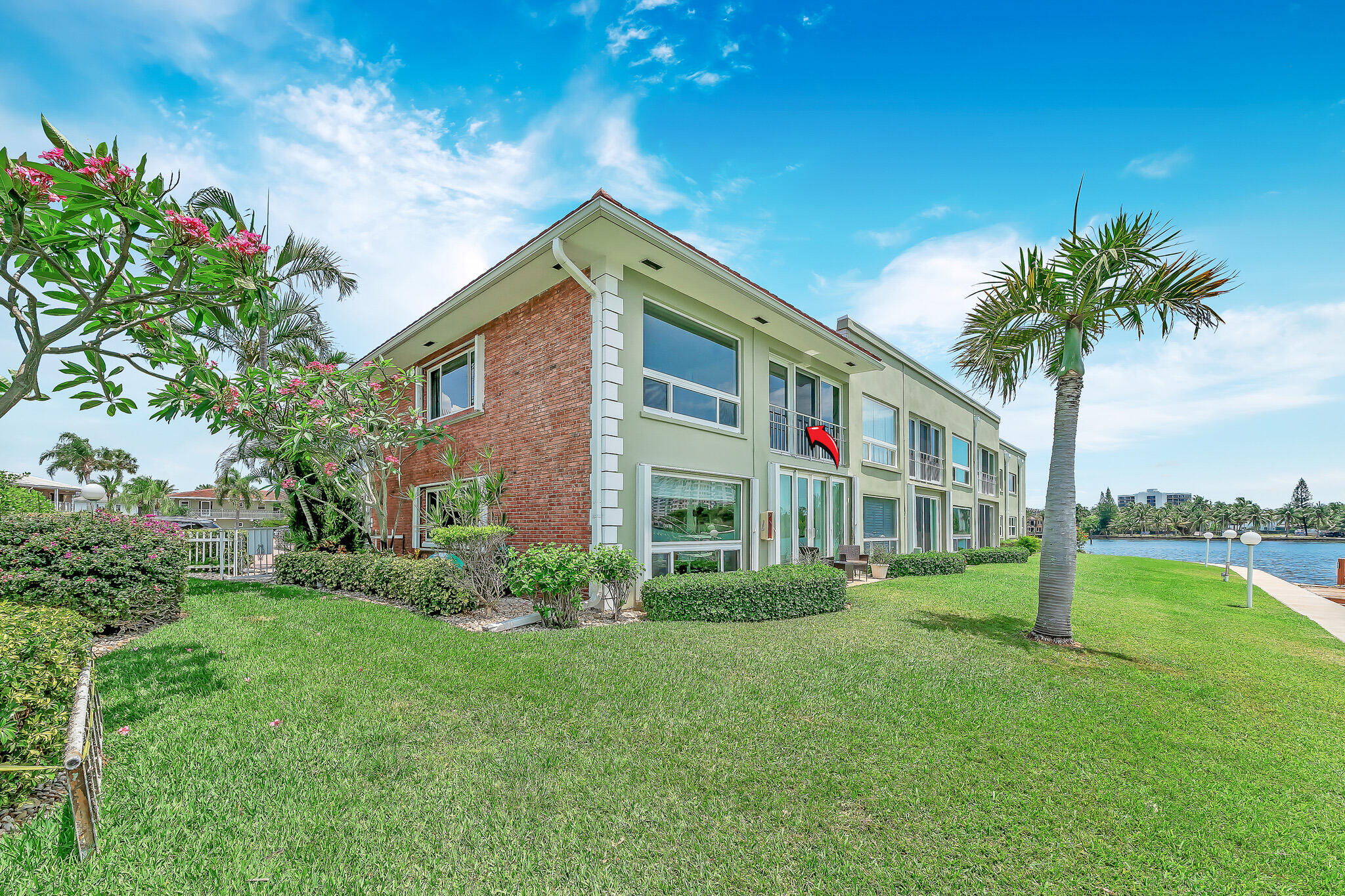 711 Northeast Harbour Terrace, Unit 4120 Boca Raton, FL 33431 - Photo 4 of 37 a front view of house with yard and green space