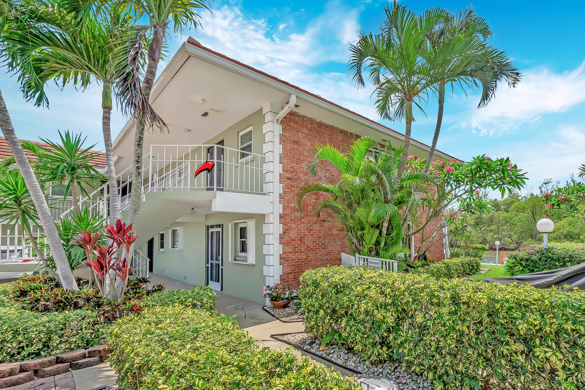 711 Northeast Harbour Terrace, Unit 4120 Boca Raton, FL 33431 - Photo 6 of 37 a front view of small house with a garden