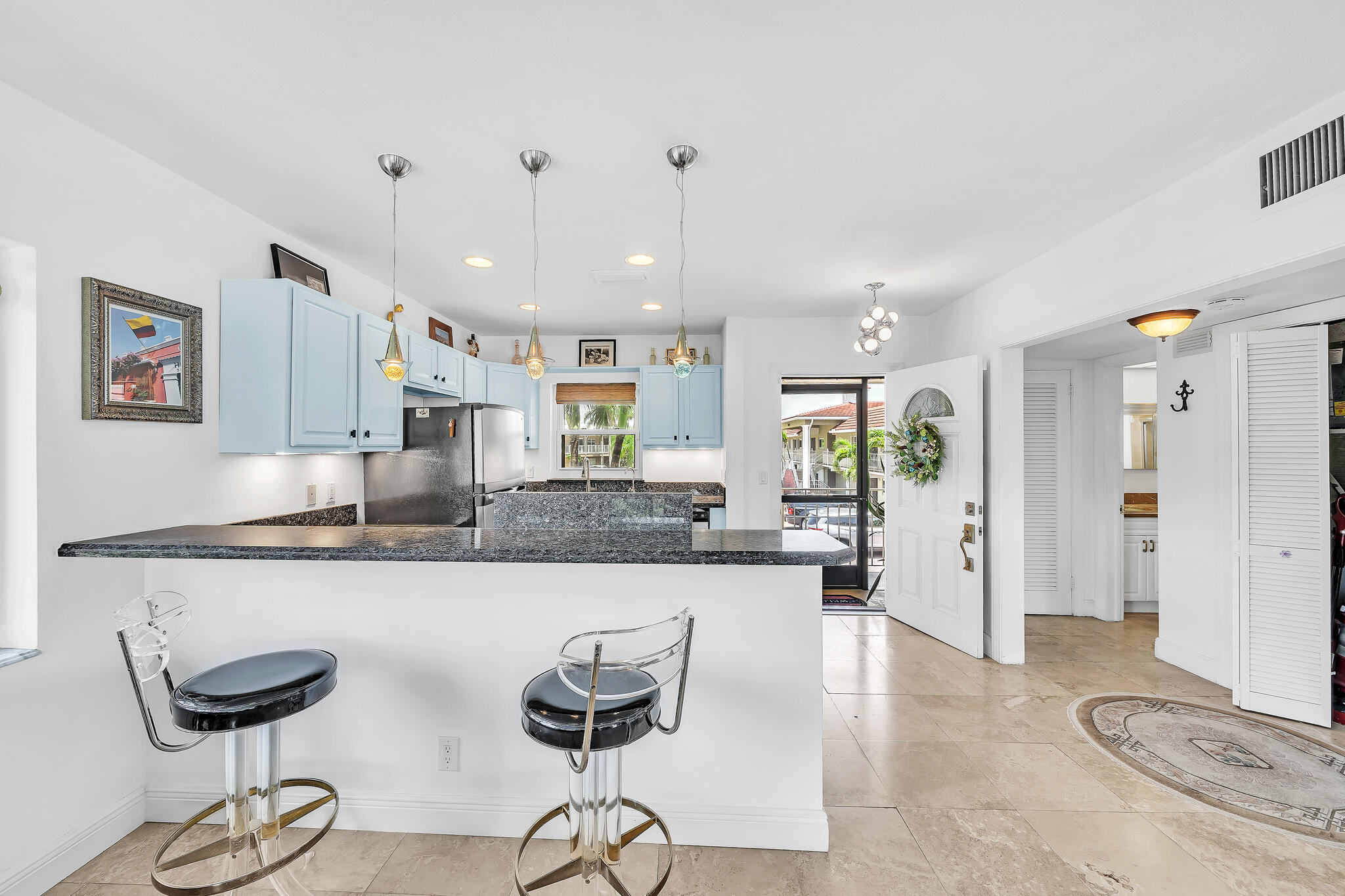 711 Northeast Harbour Terrace, Unit 4120 Boca Raton, FL 33431 - Photo 8 of 37 a large kitchen with a table and chairs in it