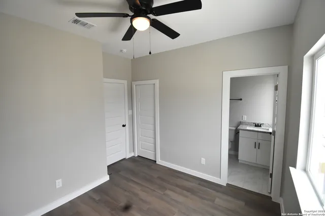 wooden floor in an empty room with a kitchen