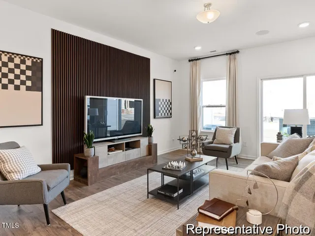 a dining room with wooden floor and a chandelier