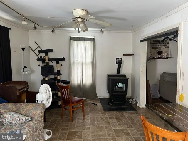a living room with furniture a flat screen tv and a window