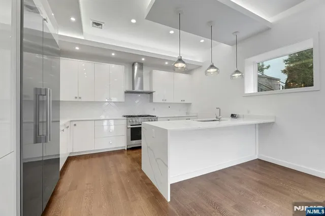 a kitchen with a sink stainless steel appliances and cabinets