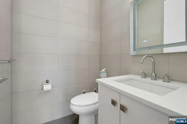 a bathroom with a sink toilet and vanity