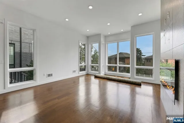 a view of room with window and wooden floor