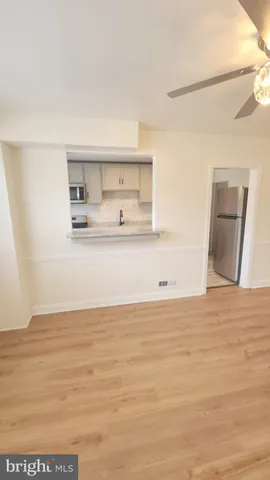 a view of kitchen and empty room