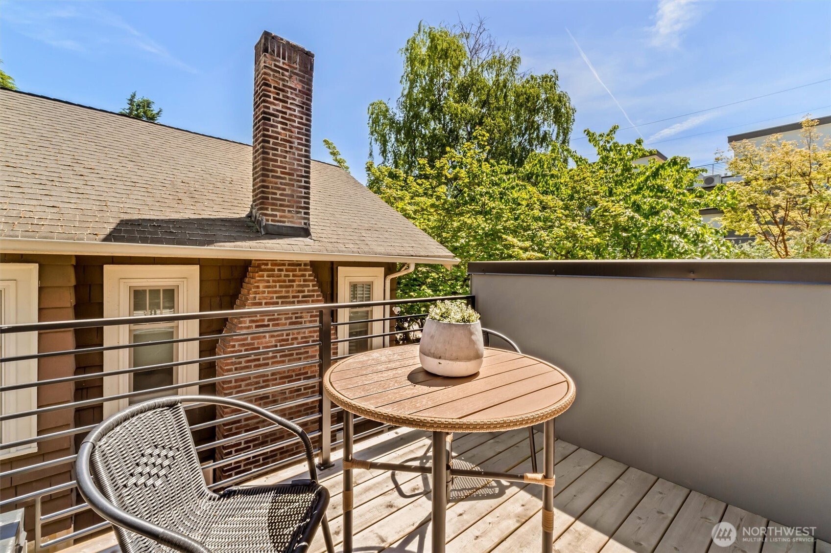 4460 Midvale Avenue North Seattle, WA 98103 - Photo 34 of 40 a balcony with table and chairs