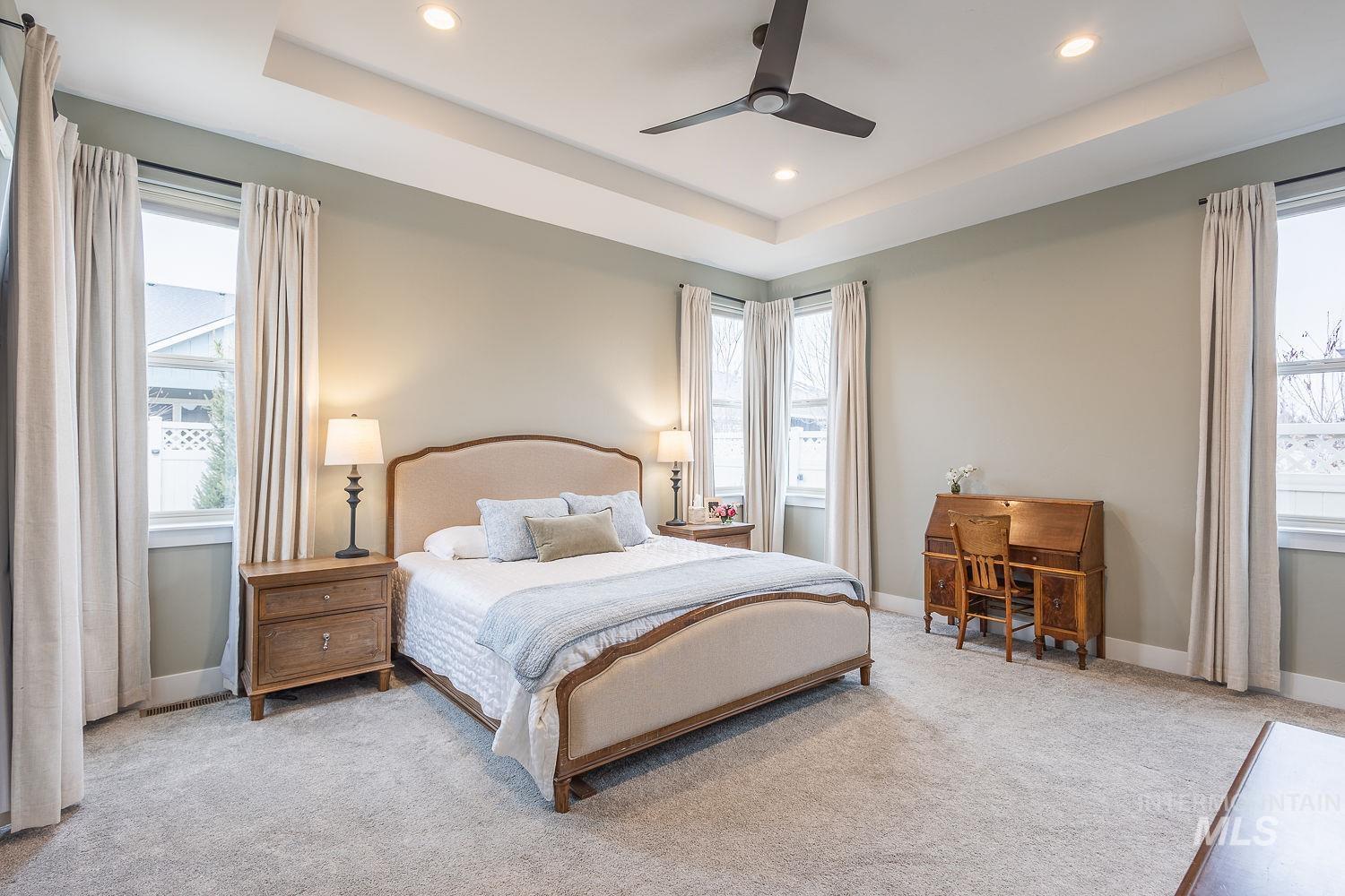 4078 West Wapoot Street Meridian, ID 83646 - Photo 18 of 46 Carpeted bedroom with ceiling fan, recessed lighting, and a tray ceiling