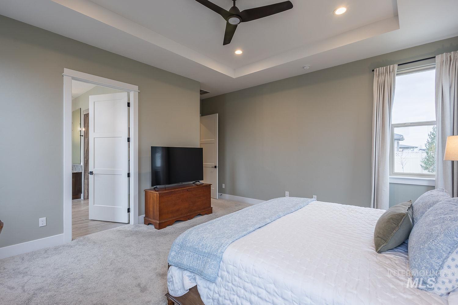 4078 West Wapoot Street Meridian, ID 83646 - Photo 20 of 46 Bedroom with carpet, recessed lighting, ceiling fan, and a raised ceiling
