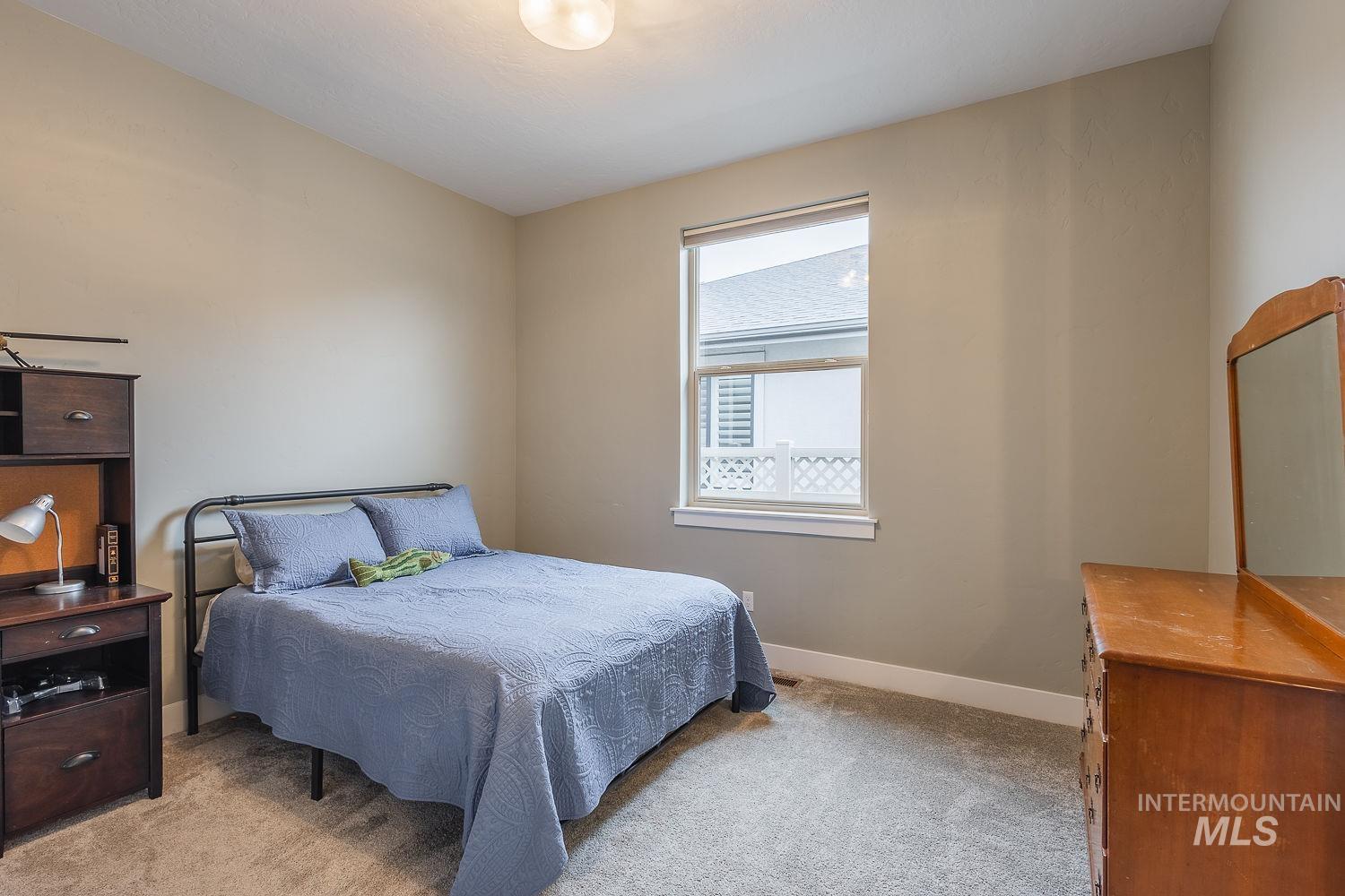 4078 West Wapoot Street Meridian, ID 83646 - Photo 32 of 46 Bedroom with light colored carpet and baseboards