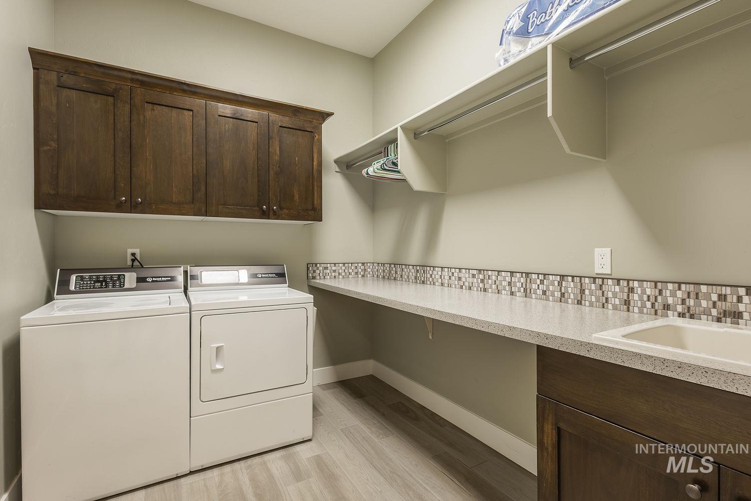 4078 West Wapoot Street Meridian, ID 83646 - Photo 38 of 46 Laundry room featuring cabinet space, separate washer and dryer, and light wood-style flooring