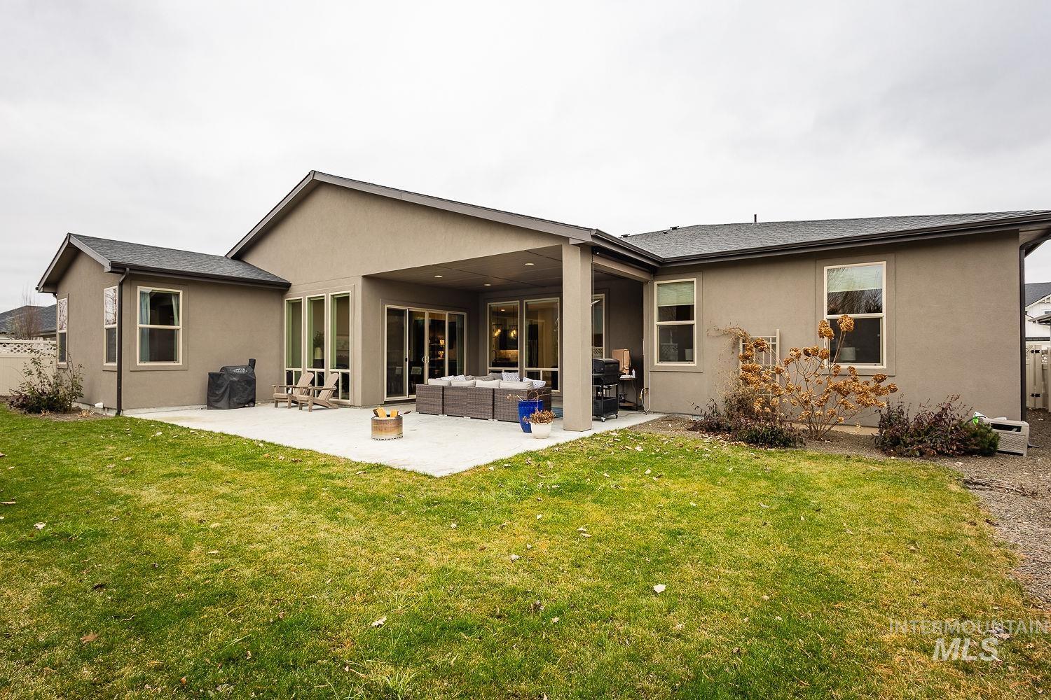 4078 West Wapoot Street Meridian, ID 83646 - Photo 43 of 46 Back of house featuring stucco siding, a patio area, outdoor lounge area, and a shingled roof