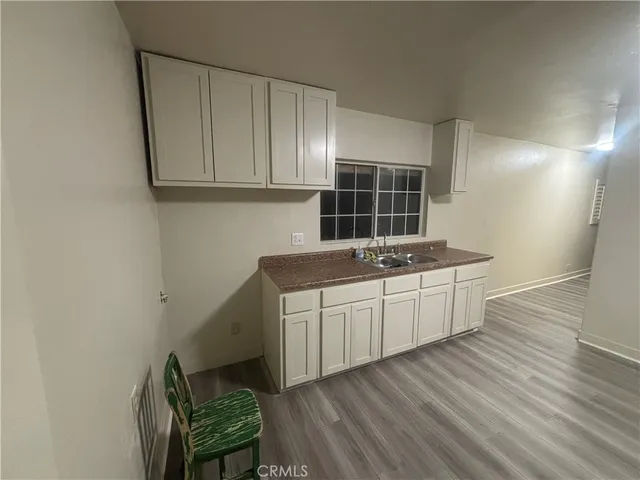 a kitchen with granite countertop white cabinets and white appliances