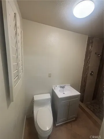a white toilet sitting next to a bathroom sink