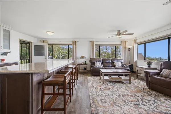 a kitchen with kitchen island granite countertop a sink a counter top space stainless steel appliances and cabinets