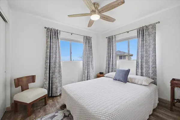 a view of a balcony with wooden floor and iron fence
