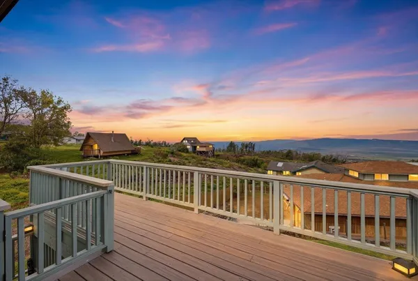 a front view of a house with yard and porch