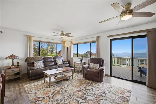 a living room with fireplace furniture and a large window