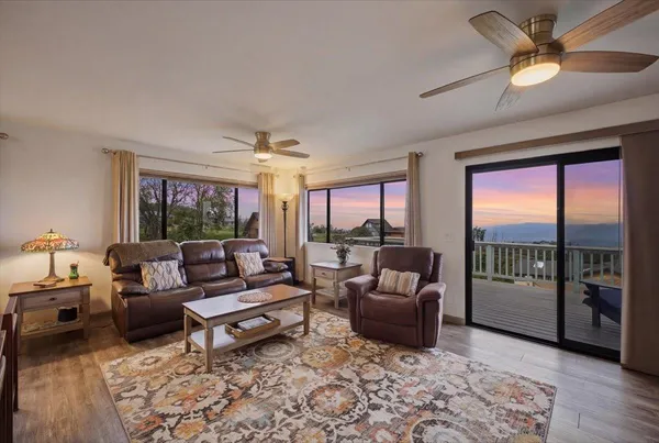 a living room with furniture large window and flat screen tv