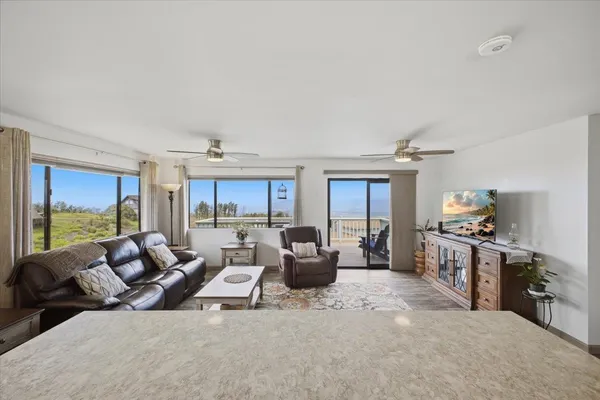 a living room with furniture a window and a table