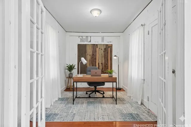 a living room with furniture and a painting on the wall