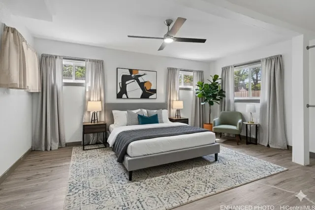 a spacious bedroom with a bed a couch and a window