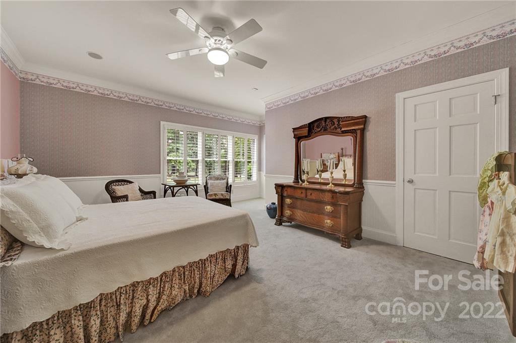 2319 Hough Road Lancaster, SC 29720 - Photo 32 of 48 a spacious bedroom with a bed and a chandelier