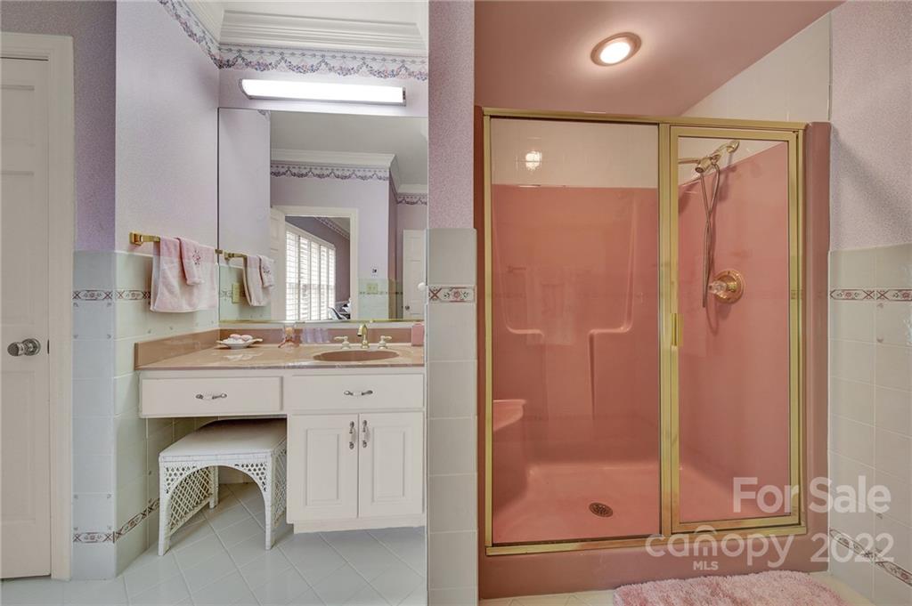 2319 Hough Road Lancaster, SC 29720 - Photo 35 of 48 a bathroom with a granite countertop sink a mirror and a shower