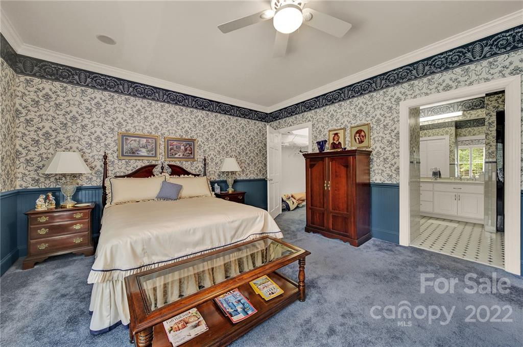 2319 Hough Road Lancaster, SC 29720 - Photo 37 of 48 a bedroom with a bed and a chandelier