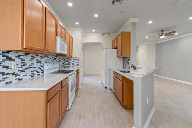 a kitchen with stainless steel appliances granite countertop a sink and a stove top oven