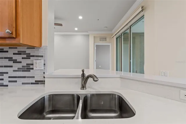 a kitchen with sink and cabinets