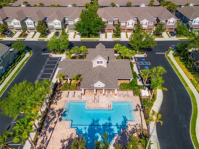 an aerial view of multiple houses with yard