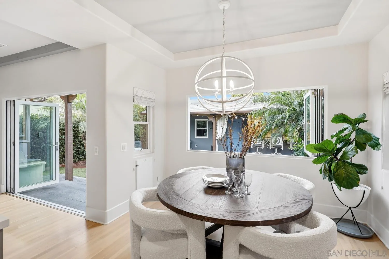 531 J Avenue Coronado, CA 92118 - Photo 14 of 58 a view of a dining room with furniture wooden floor and chandelier