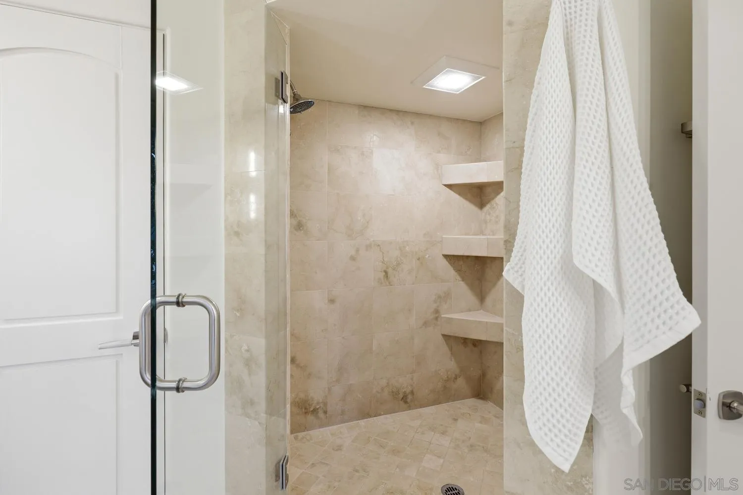 531 J Avenue Coronado, CA 92118 - Photo 28 of 58 a bathroom with a glass shower door