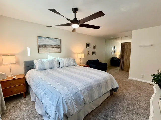 a bedroom with a bed and a chandelier