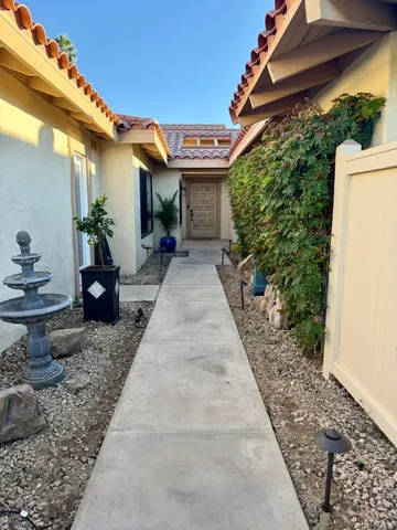 a view of a house with potted plants