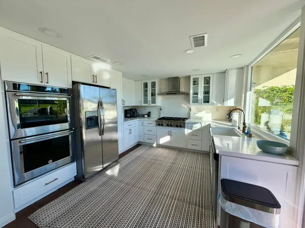 a kitchen with sink refrigerator and stove