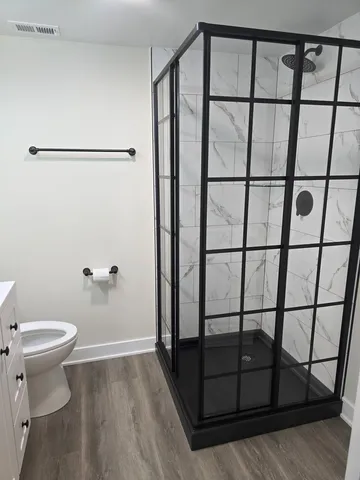 a bathroom with a toilet and a shower