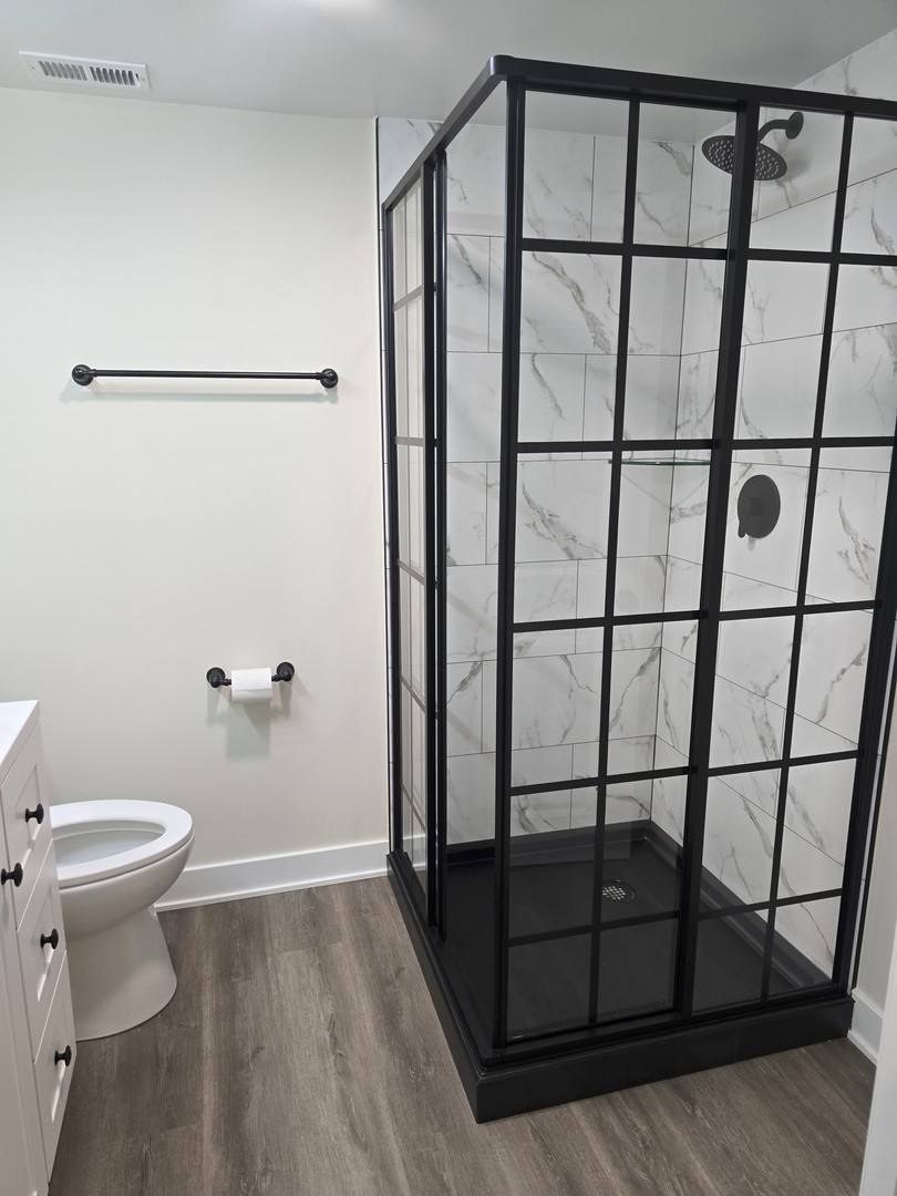 7740 West Norwood Street Chicago, IL 60631 - Photo 13 of 24 a bathroom with a toilet and a shower