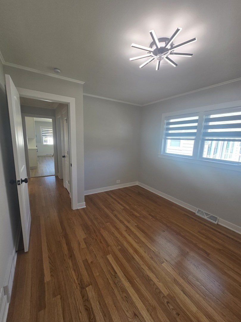 7740 West Norwood Street Chicago, IL 60631 - Photo 16 of 24 wooden floor in an empty room with a window